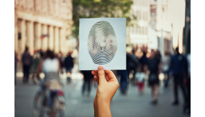 hands holding a picture of a fingerprint